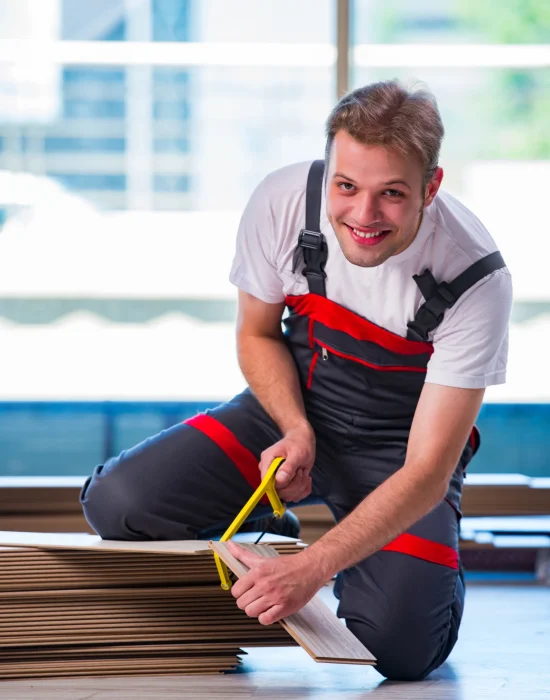 man-laying-laminate-flooring-construction-concept